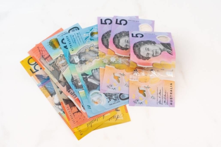 melissa-walker-horn-hK4ZB2HUtEc-unsplash-1030×688 (1) few Australian bank notes (AUD) fanned pout against a white background