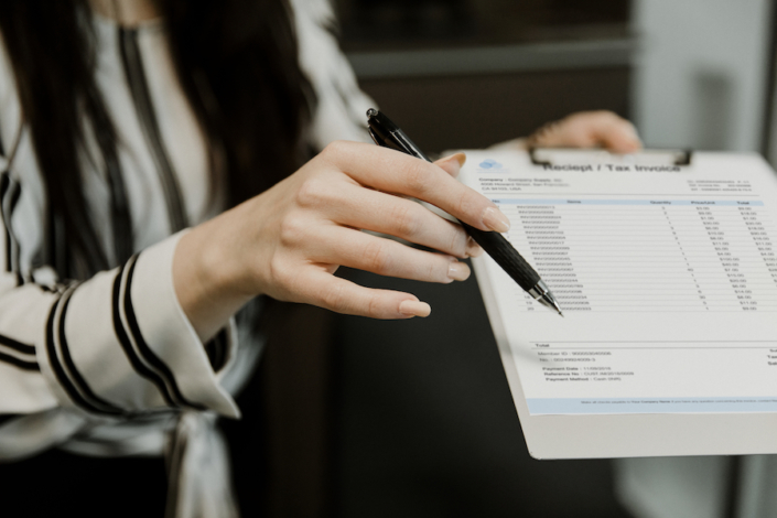 Accounts Payable Invoice – Asset, Liability, or Equity? Woman holding accounts payable invoice
